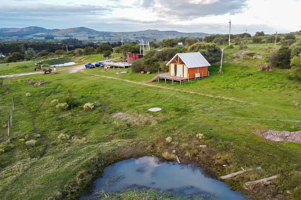 Aerial view of the Las Marías farmstead, pond and surrounding hills